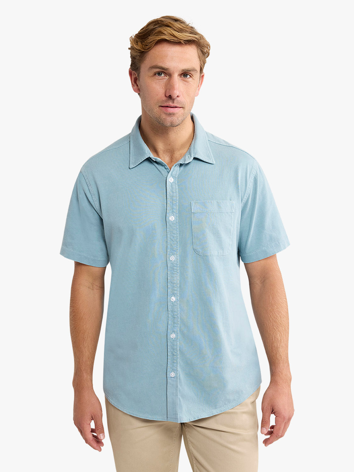 Man wearing a bay blue short-sleeved button-down shirt with a chest pocket and white buttons.