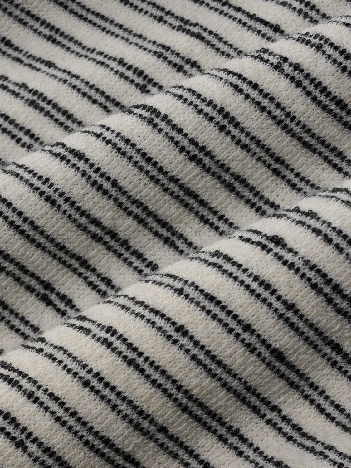 Cream and navy striped terry fabric with textured horizontal lines throughout the material.