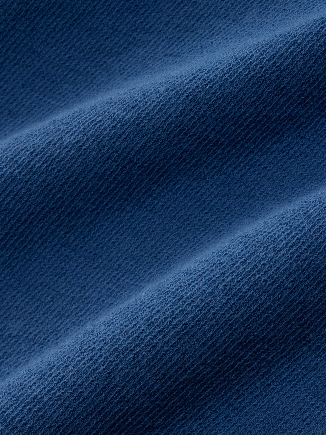 Sea blue terry crewneck fabric with textured waffle knit pattern shown in close-up detail.