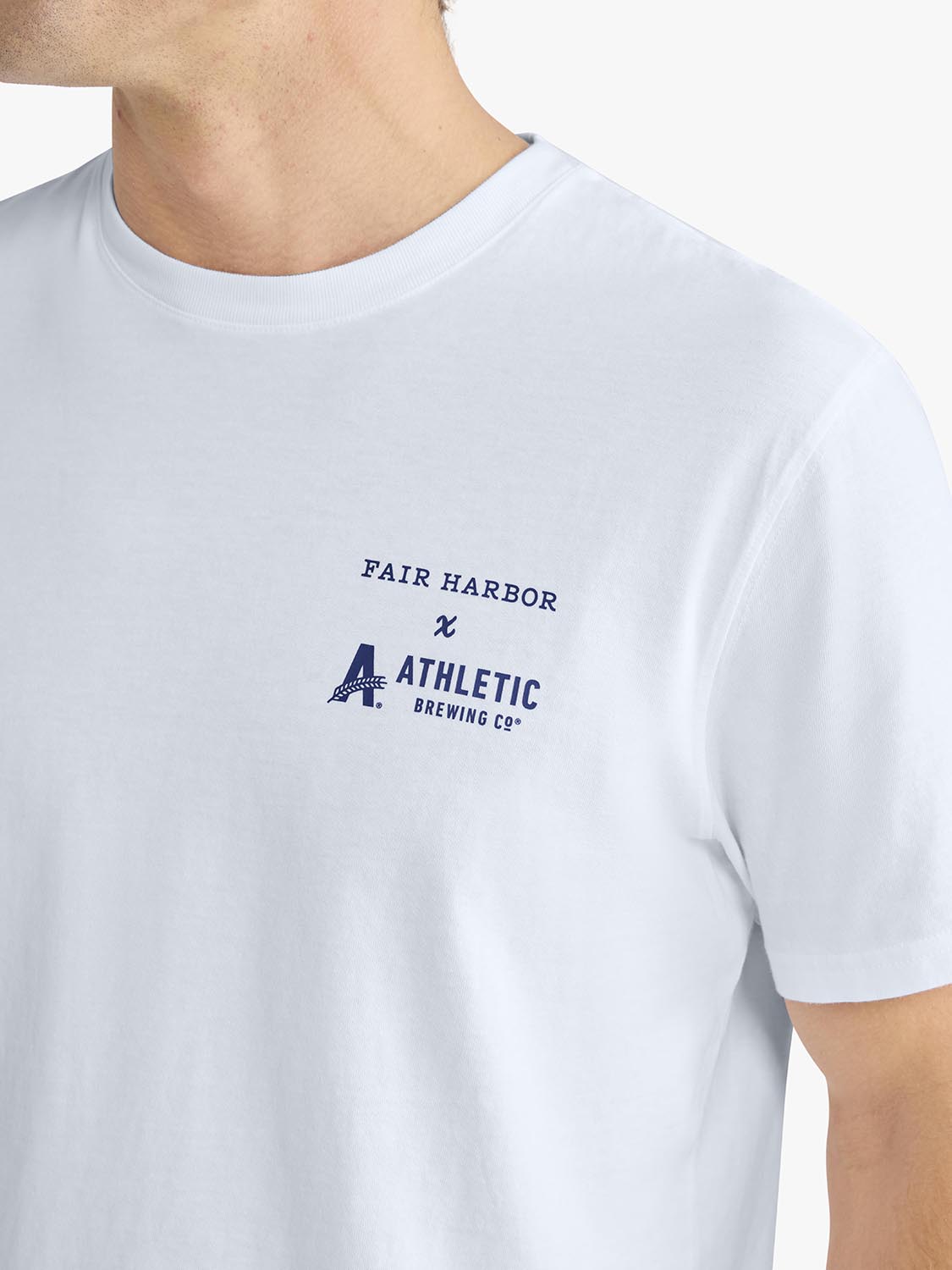 White short-sleeve t-shirt with Fair Harbor and Athletic Brewing Co. logo printed on chest.