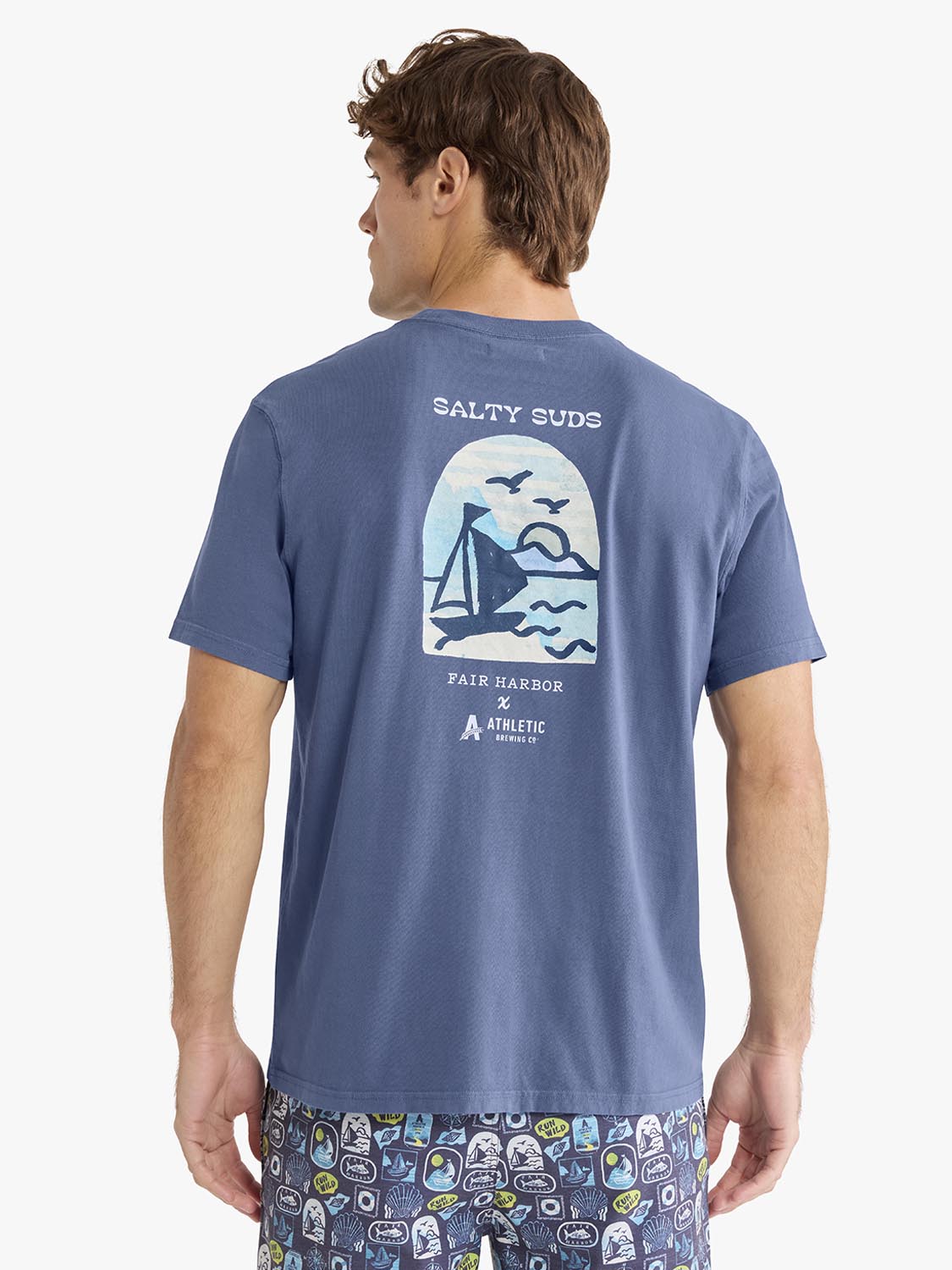 Man wearing blue graphic t-shirt with sailboat and 