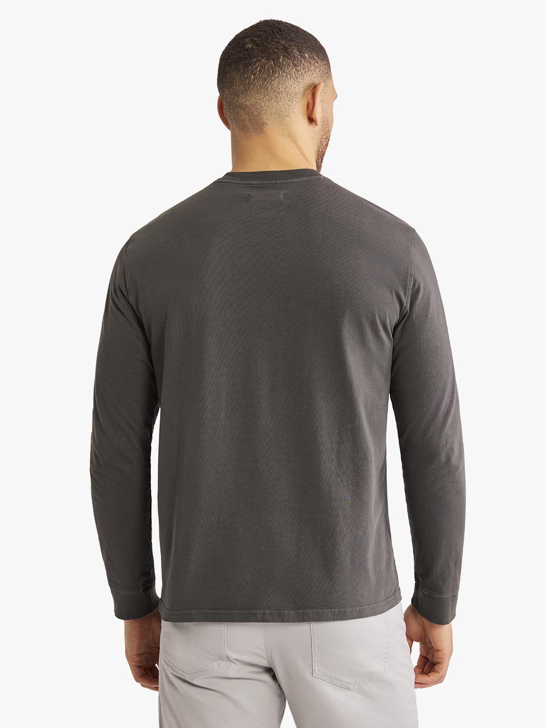 Man wearing a dark gray long-sleeve t-shirt with a crew neckline, shown from behind.