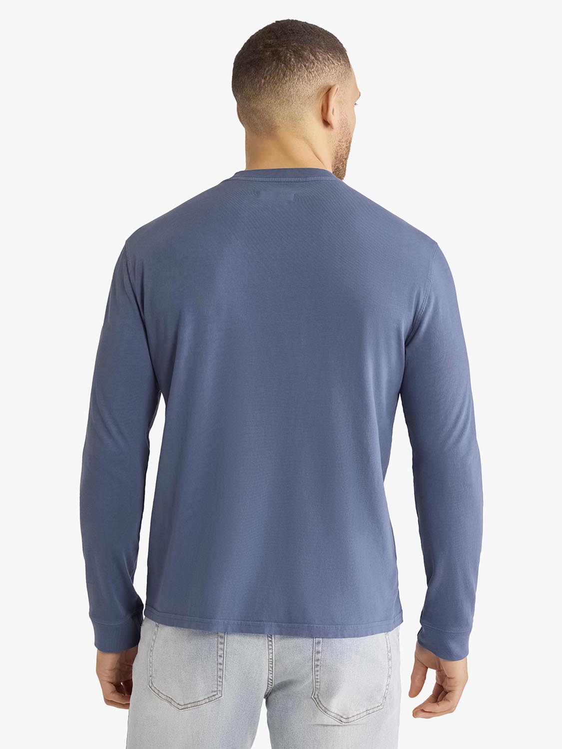 Man wearing navy long sleeve tee with crew neckline, shown from back view against white background.