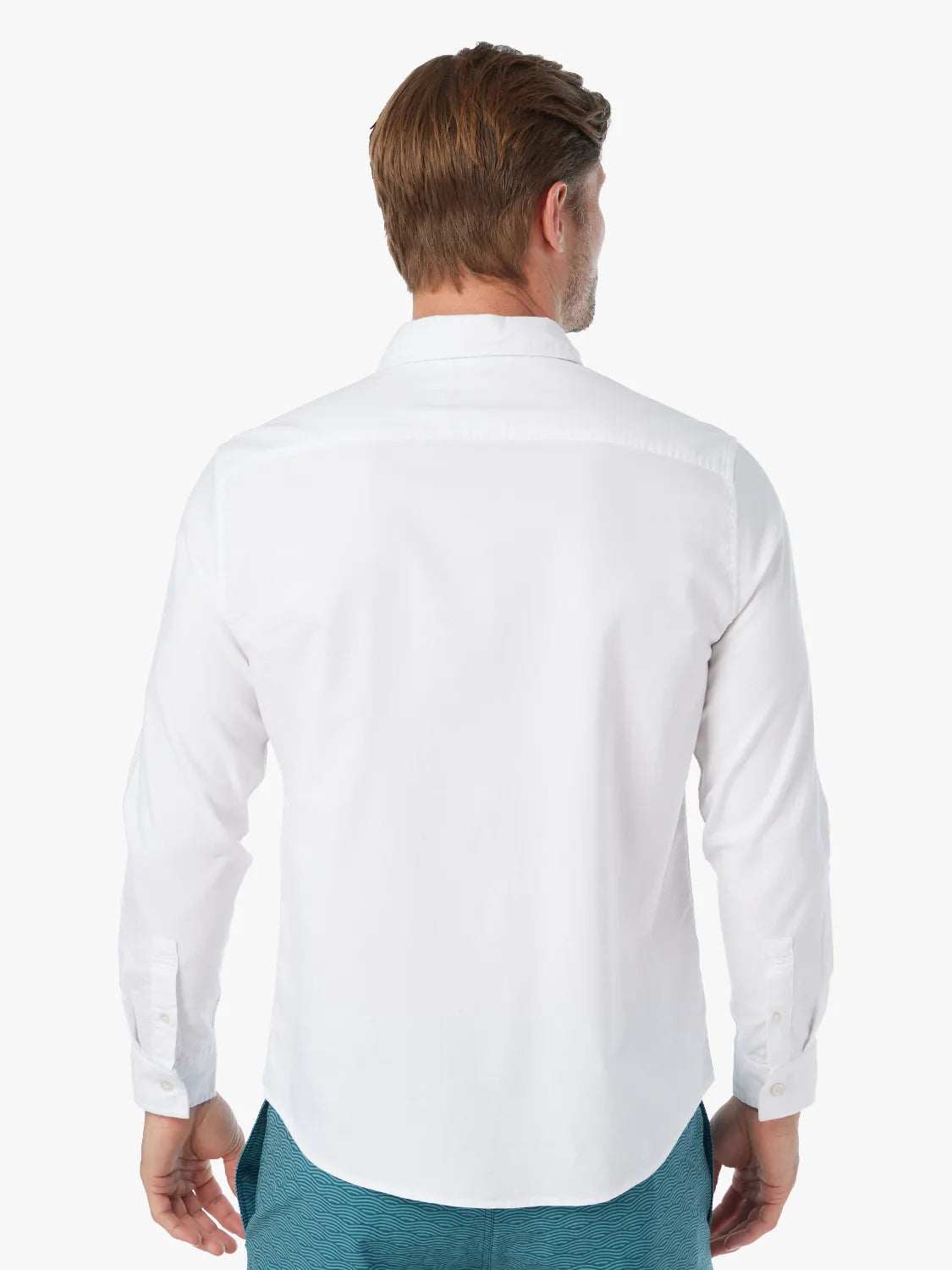 Man wearing a white oxford shirt with long sleeves and a collar, shown from behind.