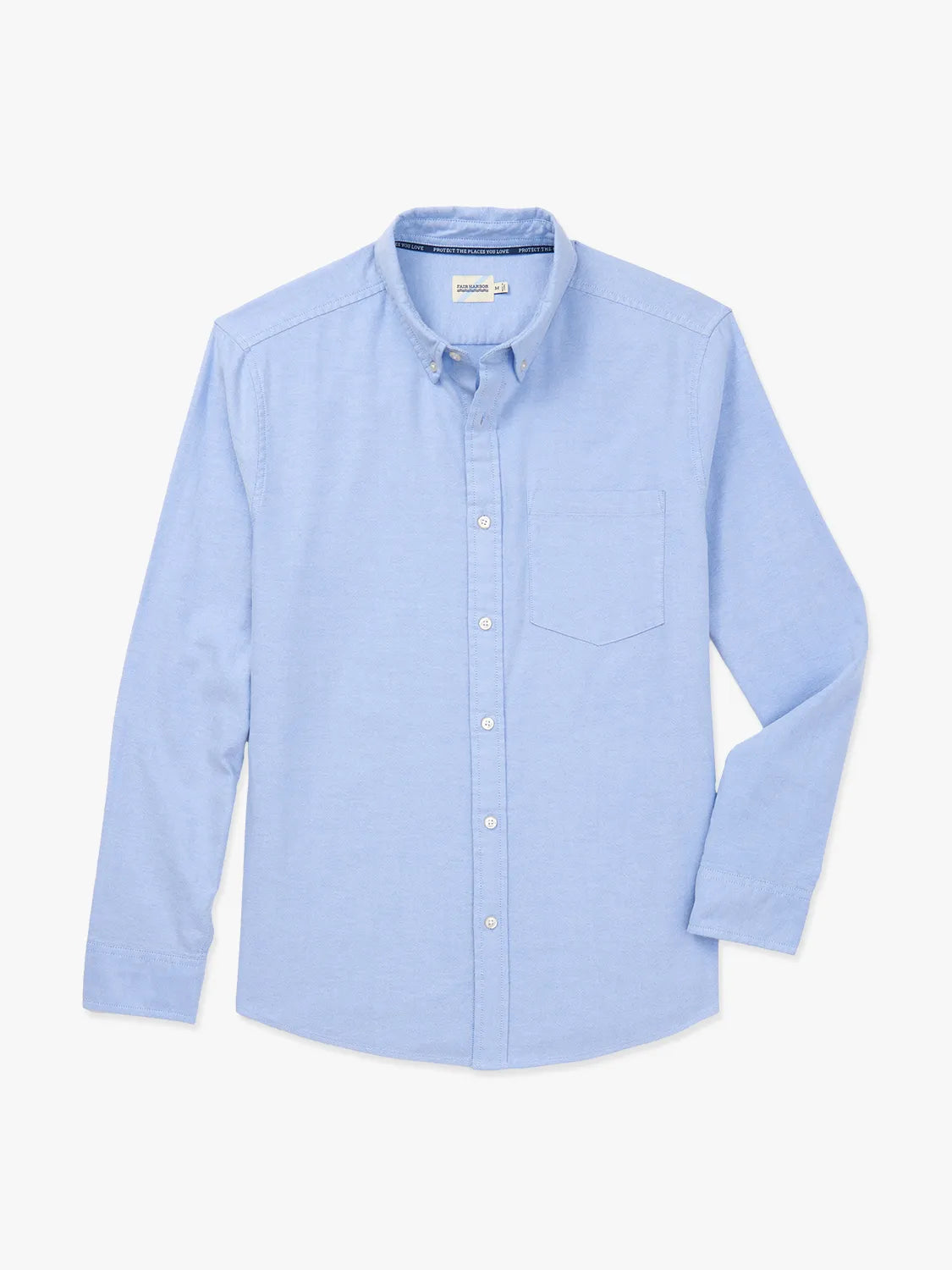 Light blue oxford shirt with button front, chest pocket, and long sleeves displayed on neutral background.