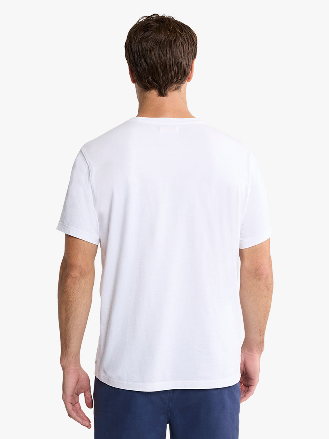 Man wearing a white short-sleeve t-shirt, shown from behind against a plain white background.