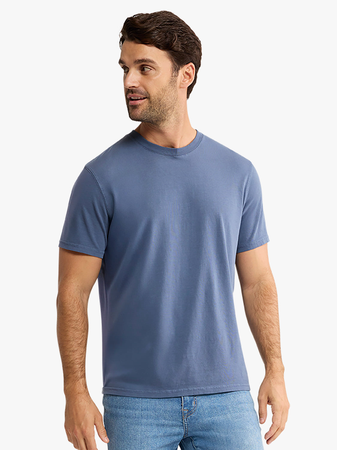 Man wearing a blue-gray short-sleeved crewneck t-shirt paired with light blue jeans.