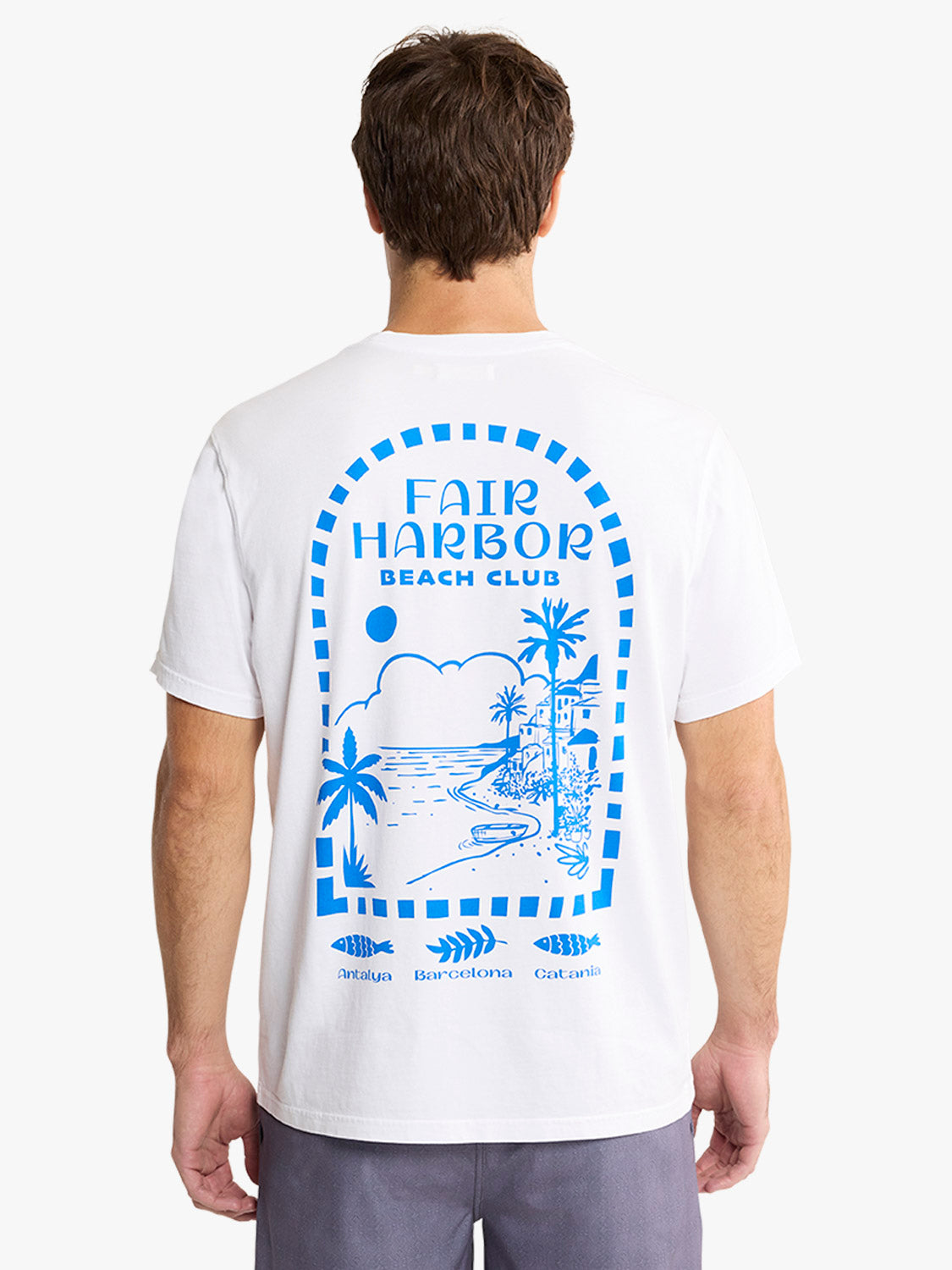 Man wearing a white t-shirt with a blue Fair Harbor Beach Club graphic printed on the back.