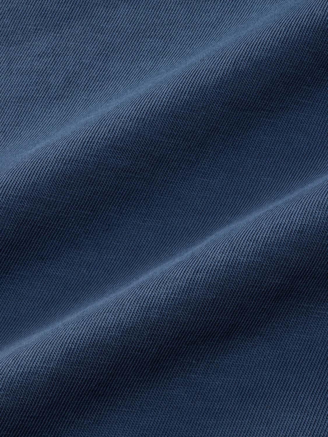 Blue ribbed graphic tee with tonal shading and diagonal fold lines across the fabric.