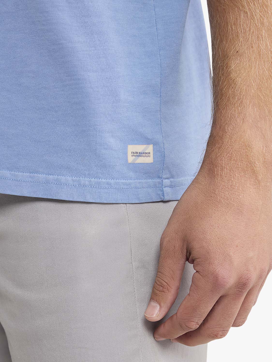 Light blue graphic tee with Fair Harbor brand label worn with khaki shorts.