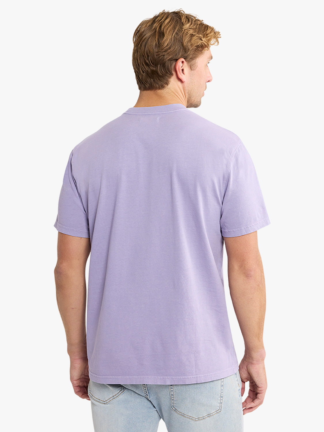 Man wearing a light purple short-sleeved t-shirt and light blue jeans, shown from behind.