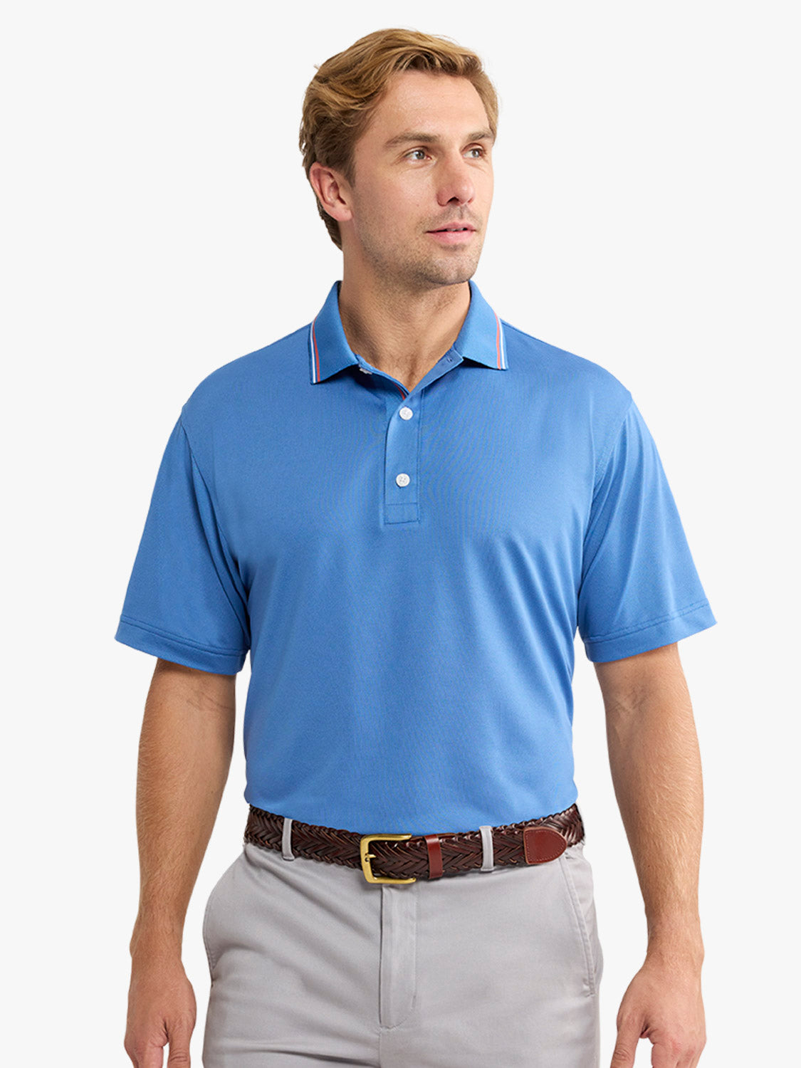 Man wearing a blue pique polo shirt with white buttons and striped collar trim.