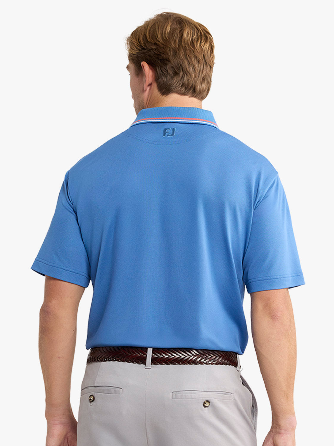 Man wearing ocean blue pique polo shirt with red trim collar, shown from back view.