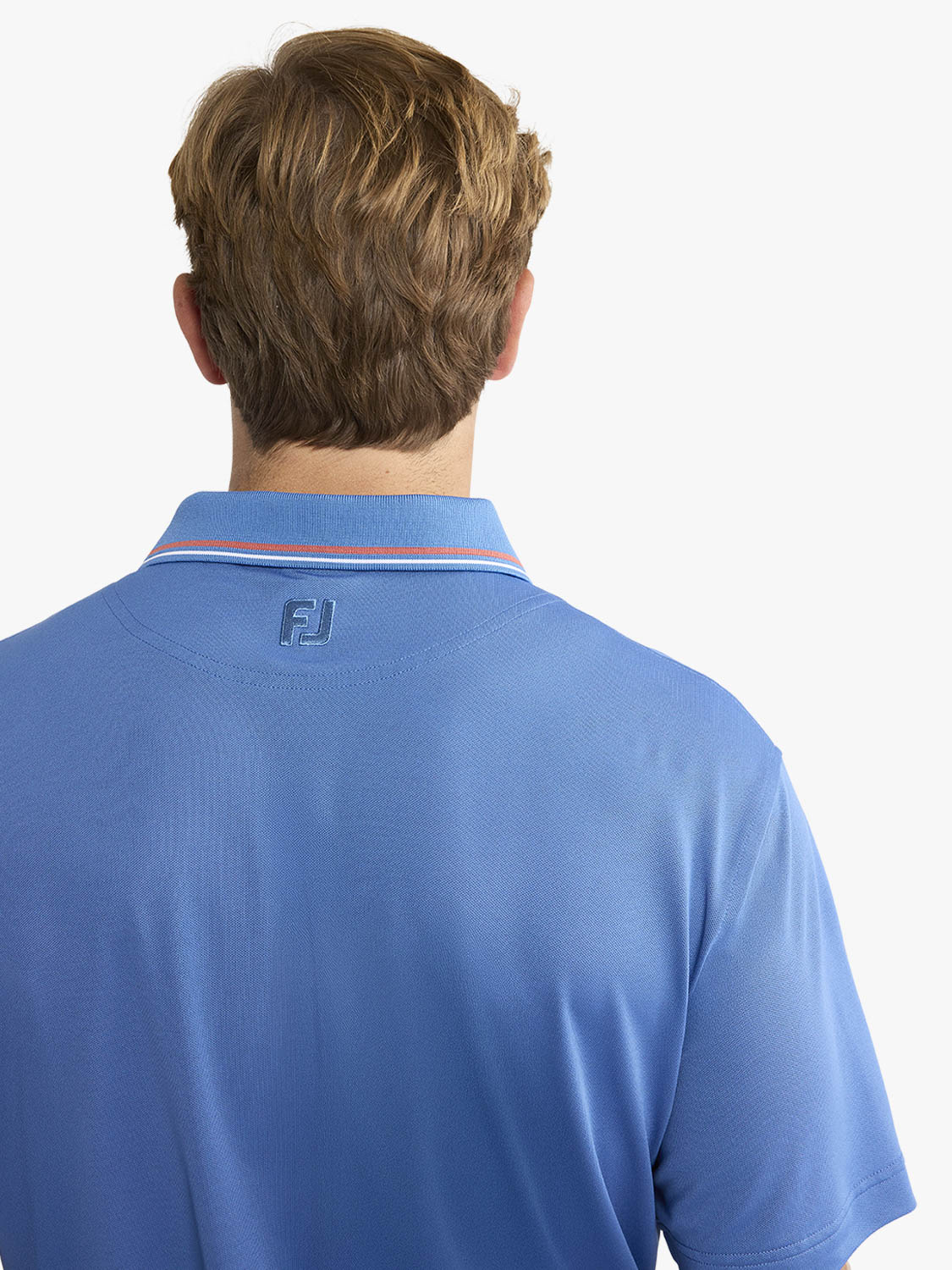 Man wearing a blue pique polo shirt with a red and white striped collar, shown from behind.