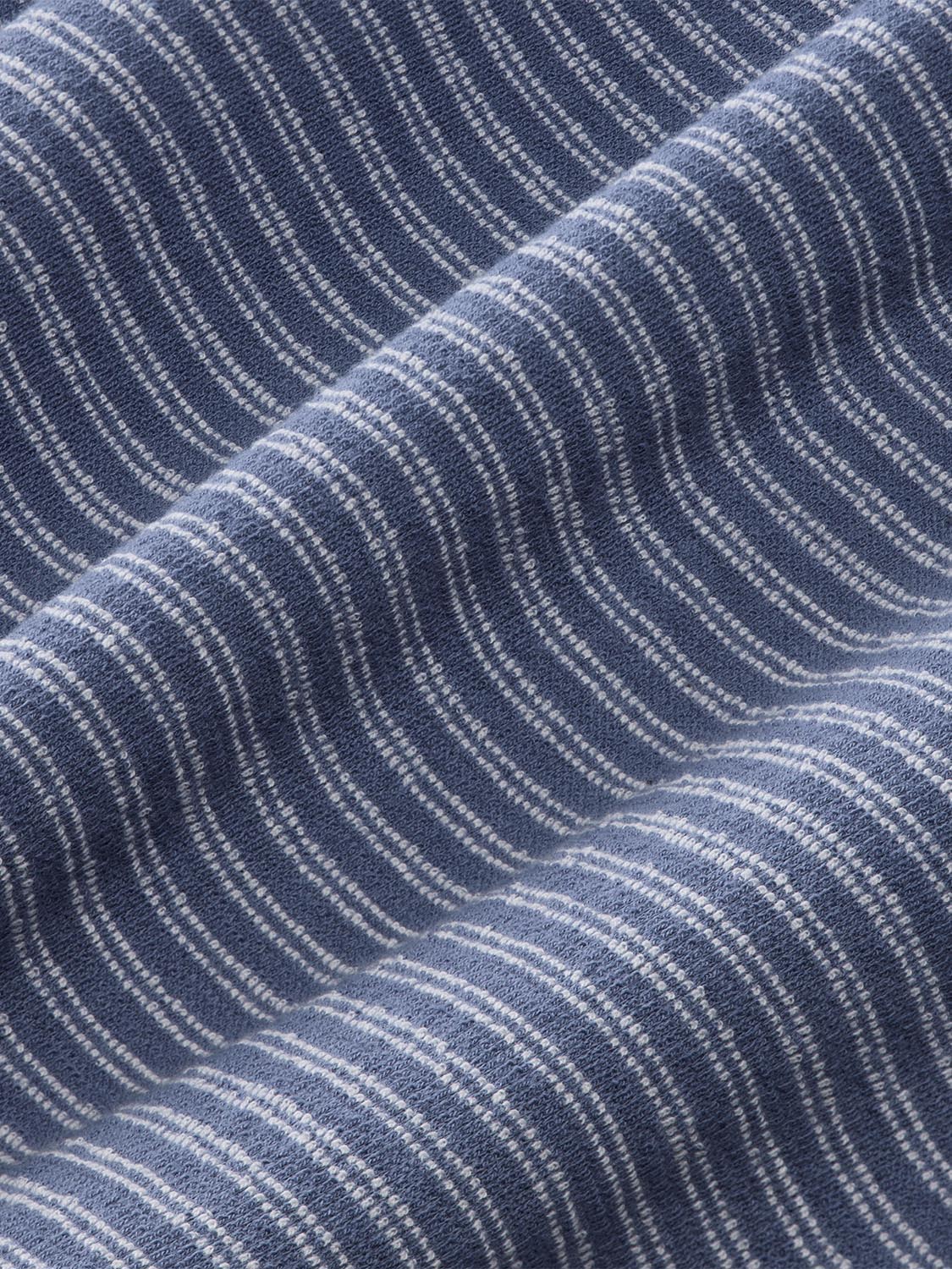 Close-up of navy blue terry fabric with white vertical stripe pattern and textured weave.