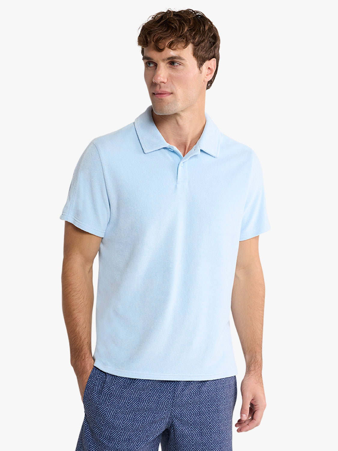 Man wearing a light blue short-sleeve polo shirt with a collared neckline and button placket.