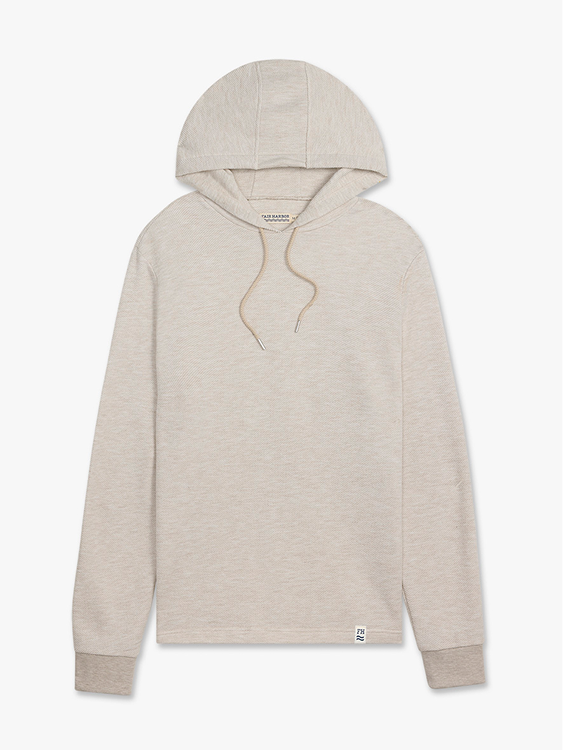 Beige pullover hoodie with drawstring hood and ribbed cuffs displayed on flat neutral background.
