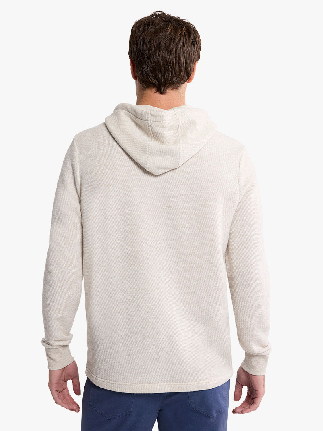 Man wearing a natural beige pullover hoodie with a drawstring, shown from the back.