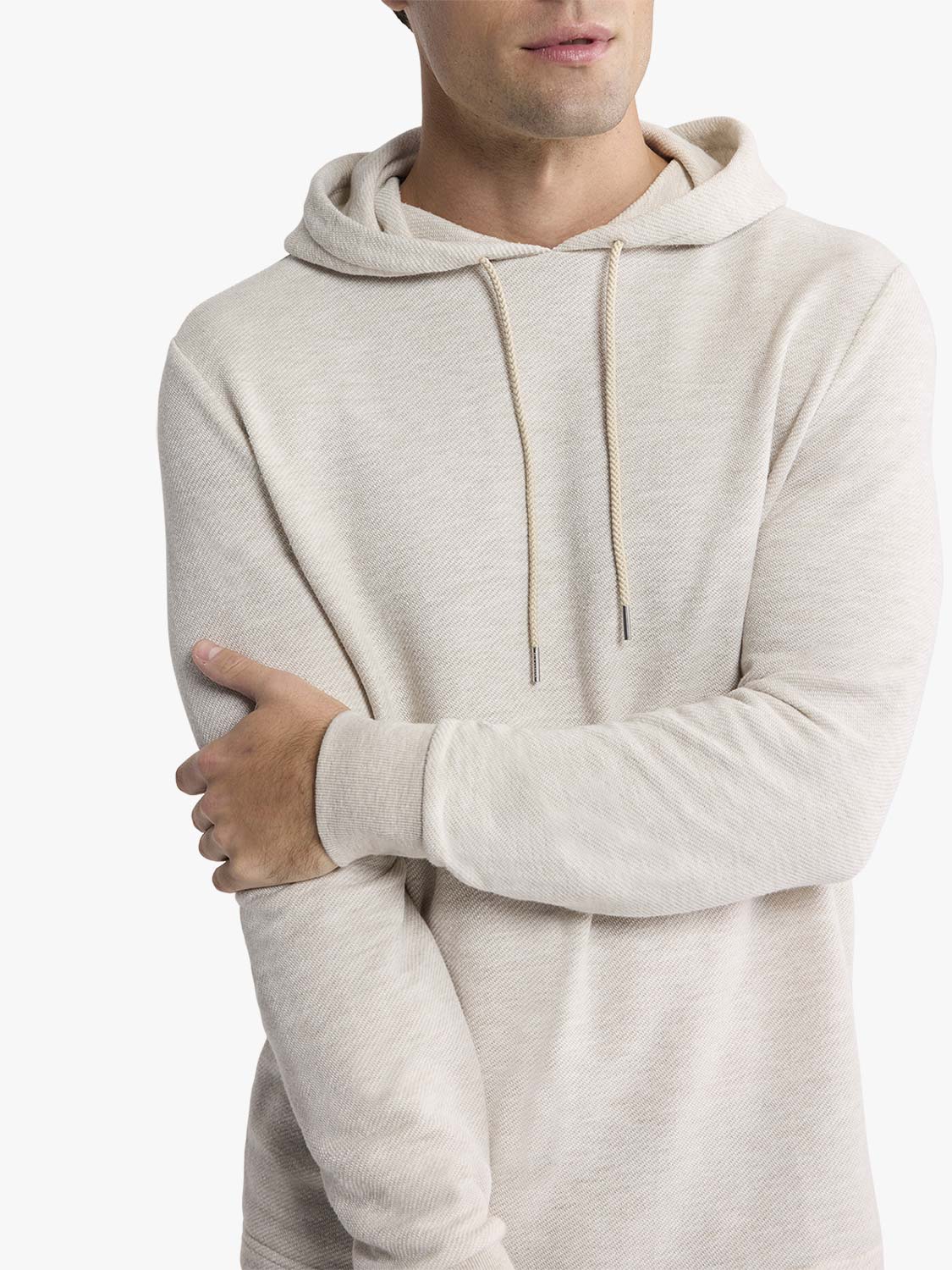 Man wearing a natural beige hoodie with drawstring and textured fabric construction.