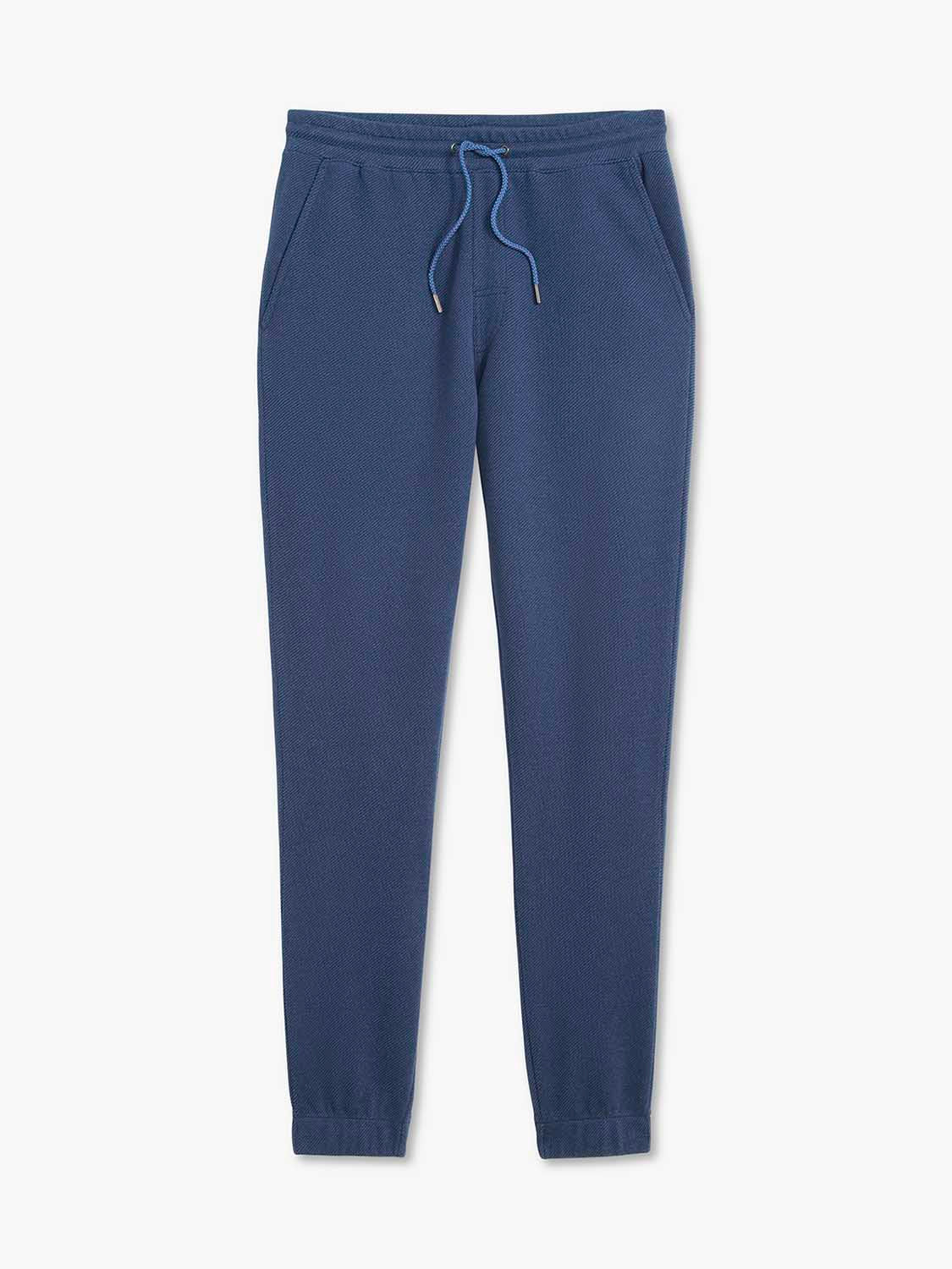 Navy sweatpants with drawstring waist, side pockets, and tapered ankle cuffs displayed flat.