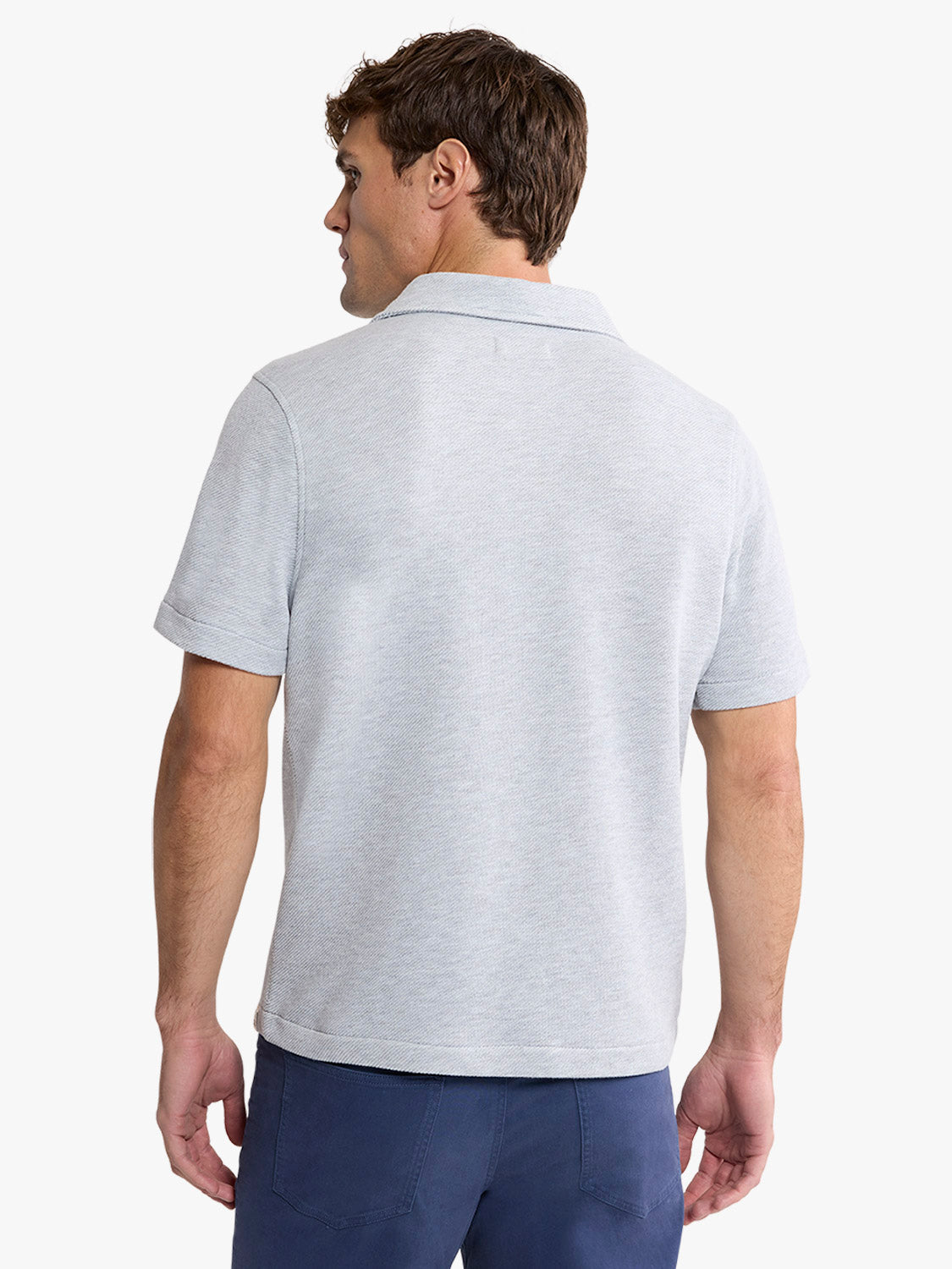 Man wearing a heather grey short-sleeve polo shirt with a collar, shown from the back view.