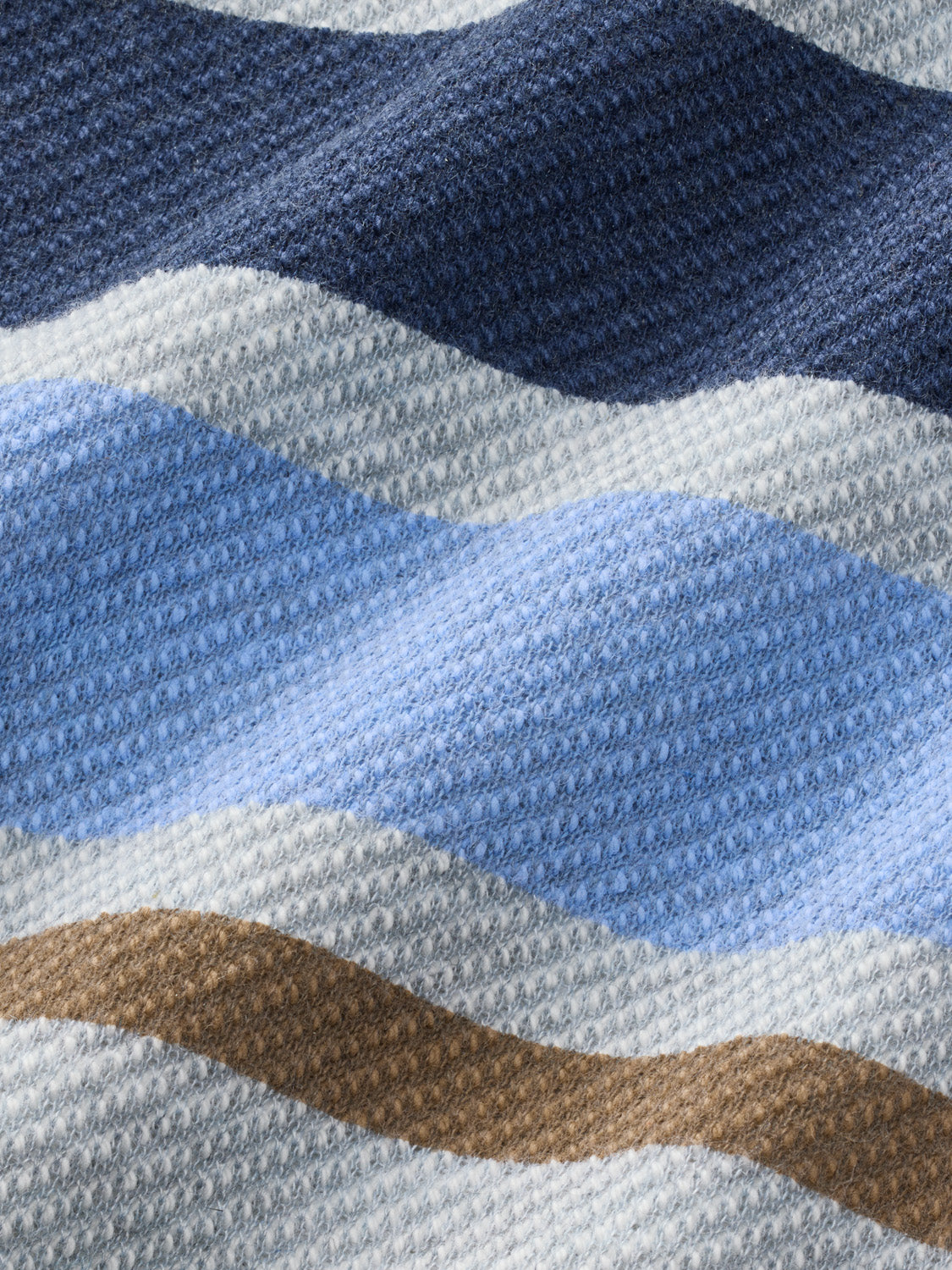 Heather grey polo shirt displaying horizontal stripes in navy, light blue, tan, and cream colors.