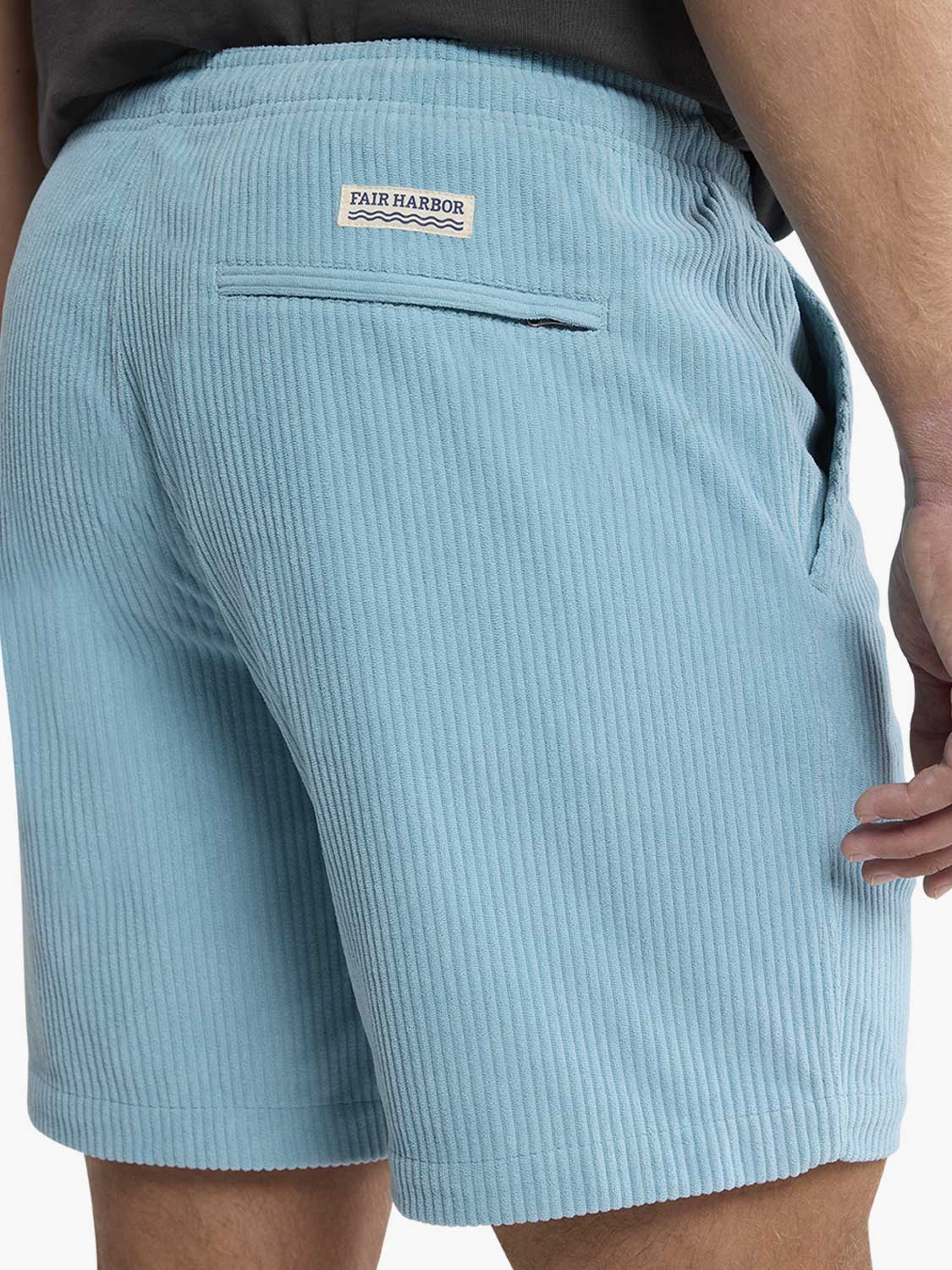 Bay blue corduroy shorts with Fair Harbor brand label and back pocket detail visible.